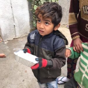 A young child with the food packet given to him