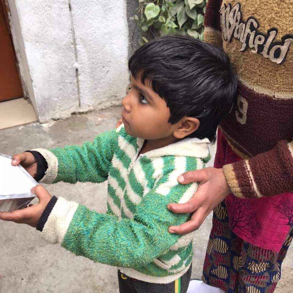 Child getting food packet at Not Another Child center