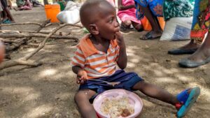 Group of children having food at Not Another Child center