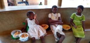 Children enjoying a meal at Not Another Child center