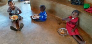 Children enjoying a meal at Not Another Child center