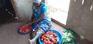 A Malawi mother preparing food at Not Another Child center
