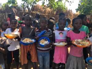 Group of kids holding food plates in their hands