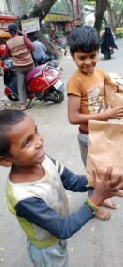 Two boys holding the food packages