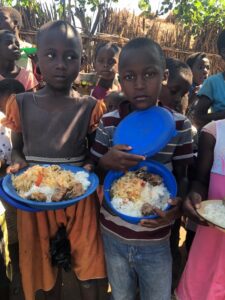 Boy and girl holding the plates filled with food