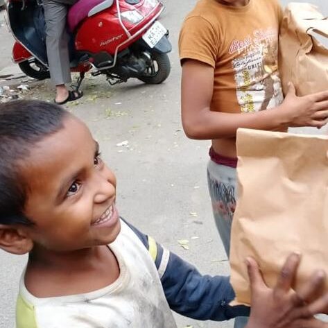 Two boys holding the food packages